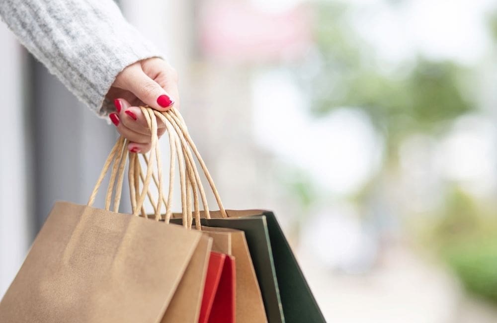 An image of a woman carrying gifts for an article about Amazon gifts under $50.