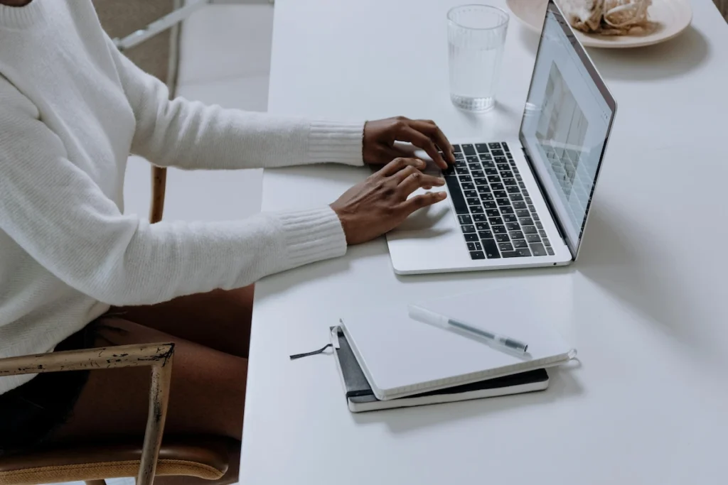 person typing on a laptop at a table