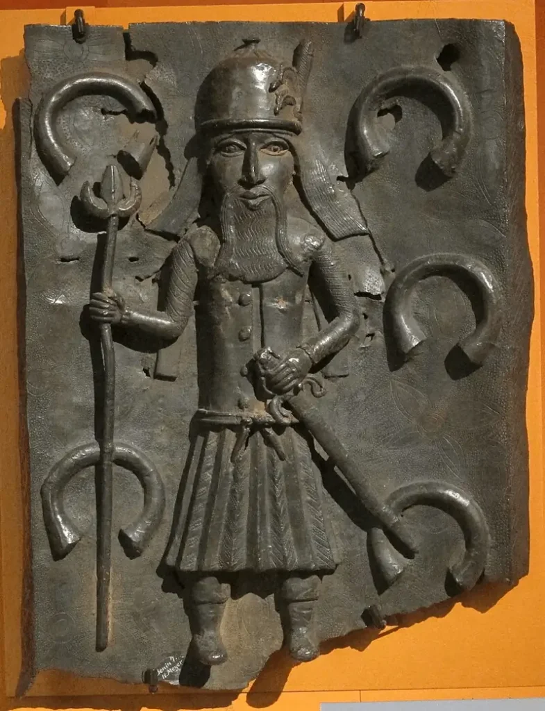 A Benin Bronze depicts a Portuguese merchant with brass manillas in the background. Photo: Wikimedia Commons