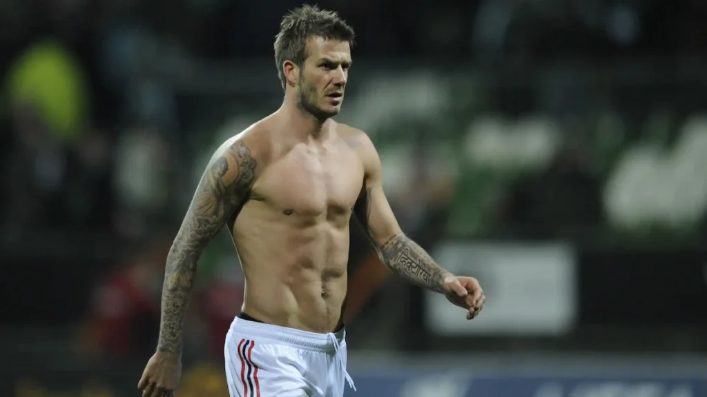 David Beckham showing his tattoo sleeves during a football match