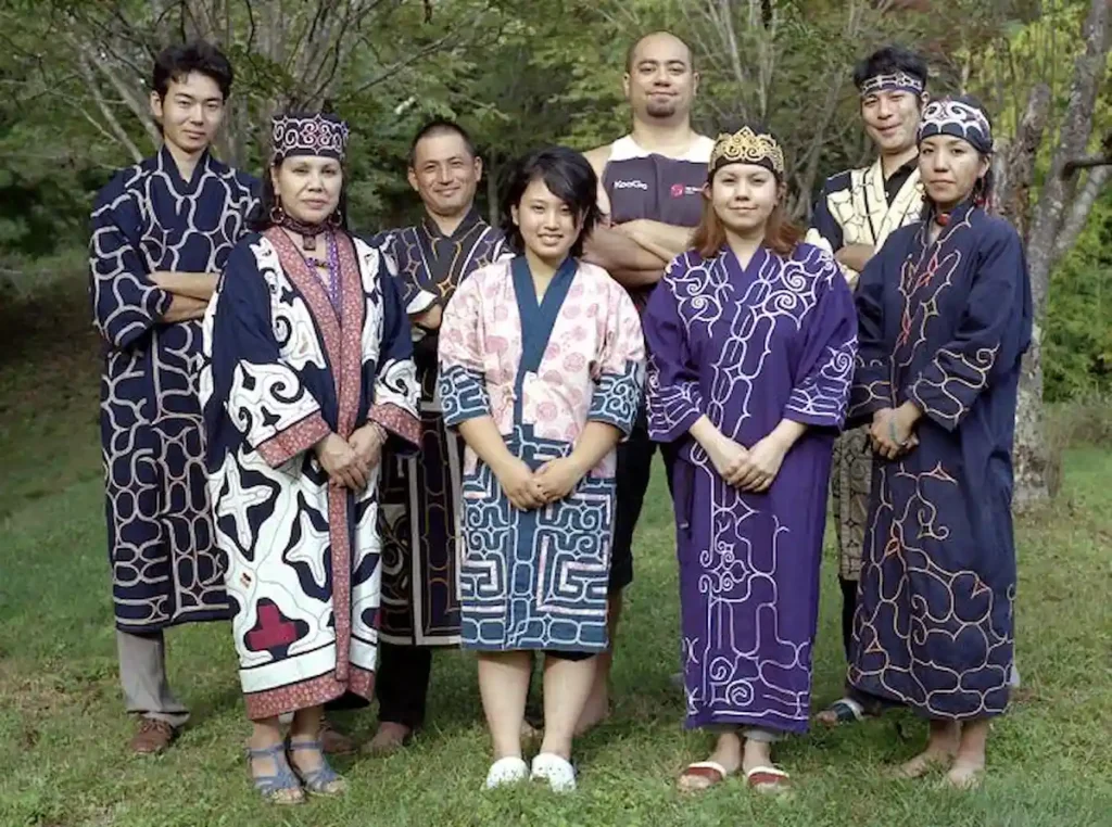 Ainu people wearing traditional clothing during a cultural ceremony in Hokkaido.