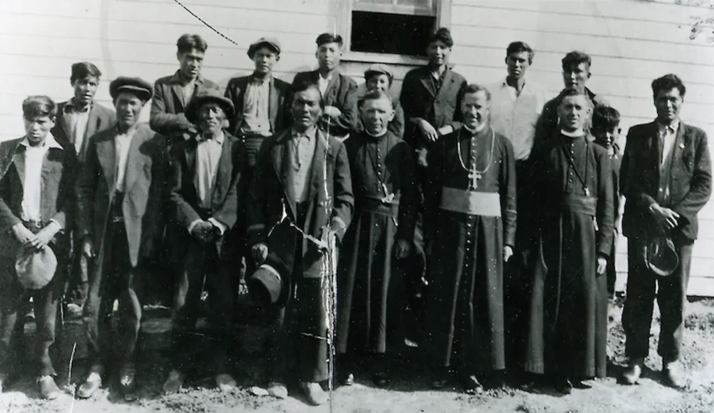Michif people wearing Métis sashes and traditional clothing at a heritage celebration.