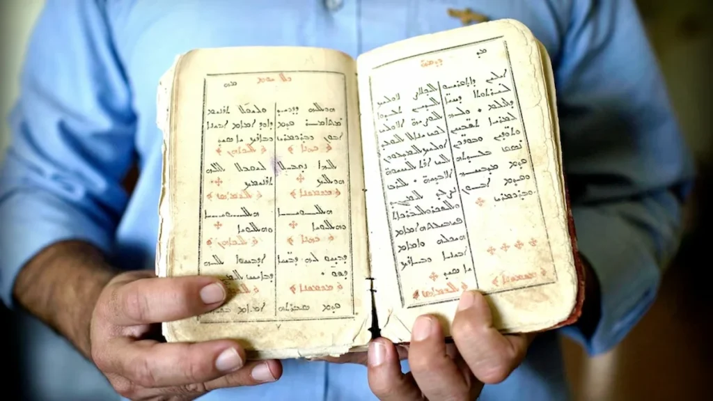 Ancient Aramaic written on the papaer symbolizing the endangered languages list