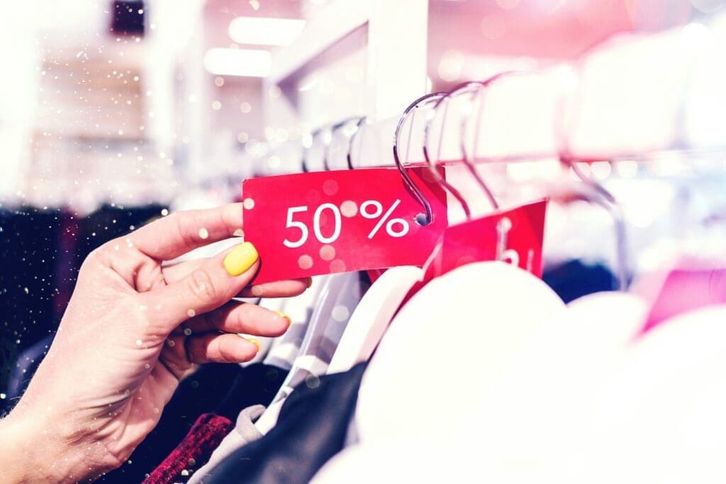 A person holding a price tag in their hands, representing the emotional and social cost of connection in the digital age.