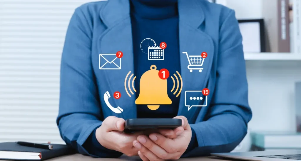 A person holding a smartphone surrounded by floating icons of notifications, missed calls, messages, and calendar alerts symbolizing constant digital distractions and notification overload.