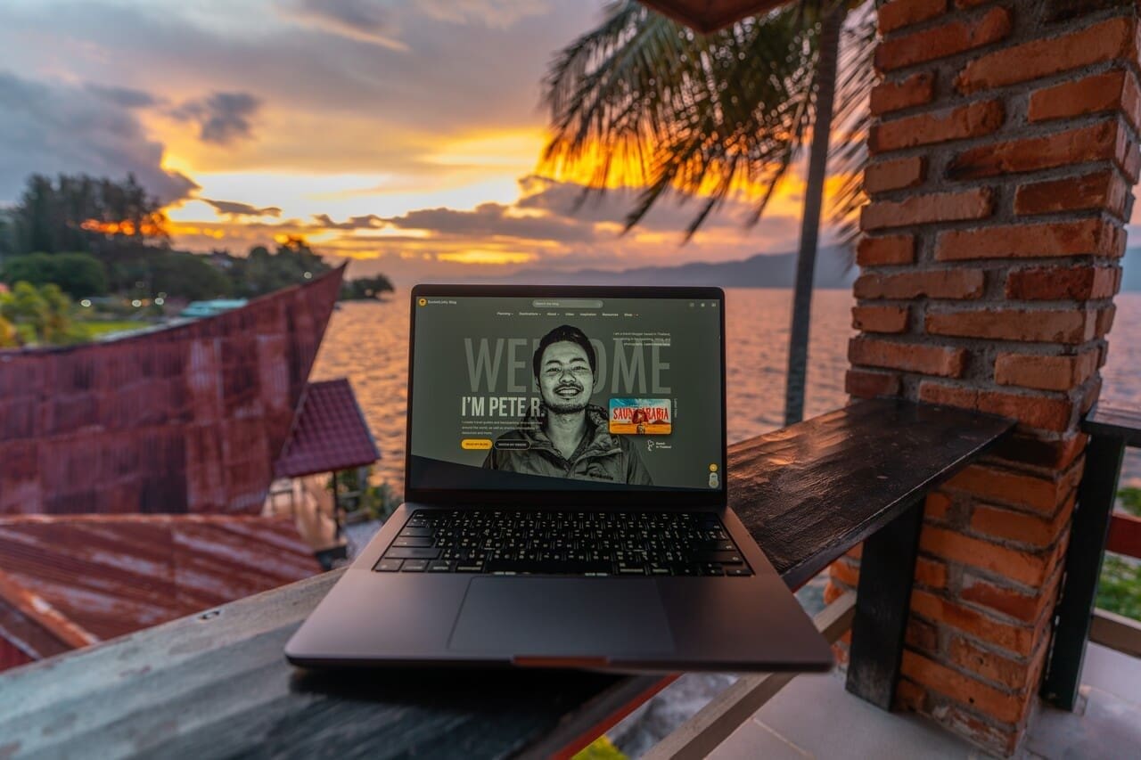 Laptop, palm trees, and a sunset: documenting travel moments from a rooftop perch.