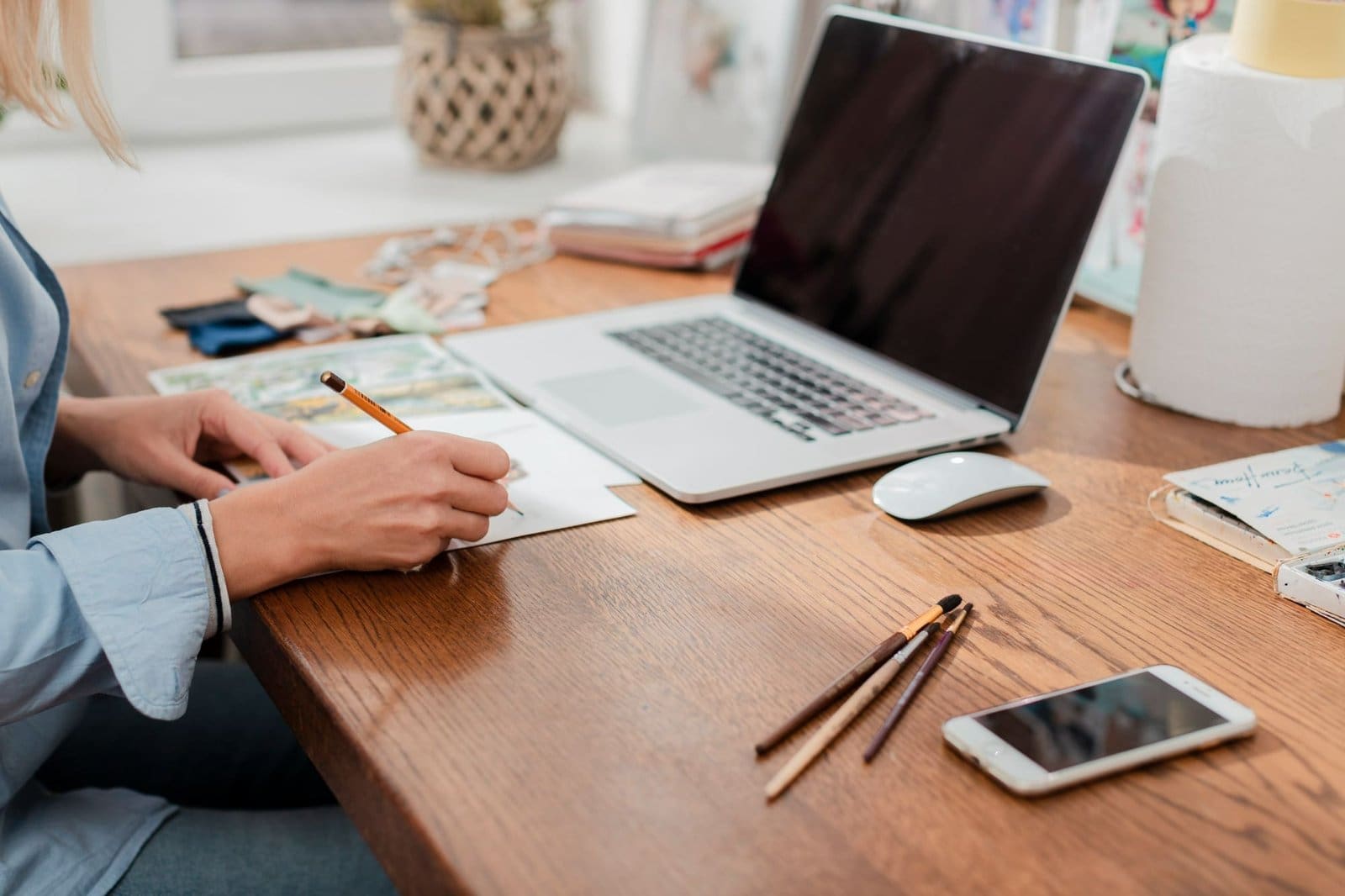 Creator drafting a clear client communication email on a laptop with a calendar beside it. Creator drafting a clear client communication email on a laptop with a calendar beside it.